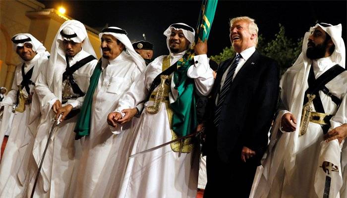 Donald Trump with sword in hand dances to the tunes of Arabian music