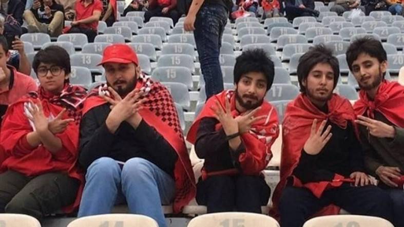 A group of Iranian female soccer fans use false beards to defy ban in stadium