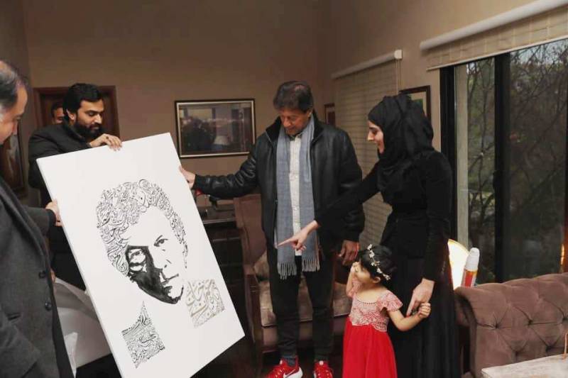 Calligraphy expert from UK Sonia presents PM Imran Khan with a portrait