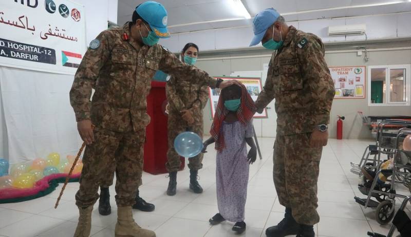 Pakistani peacekeepers help children in physio therapy program at Pakistani field hospital in Sudan